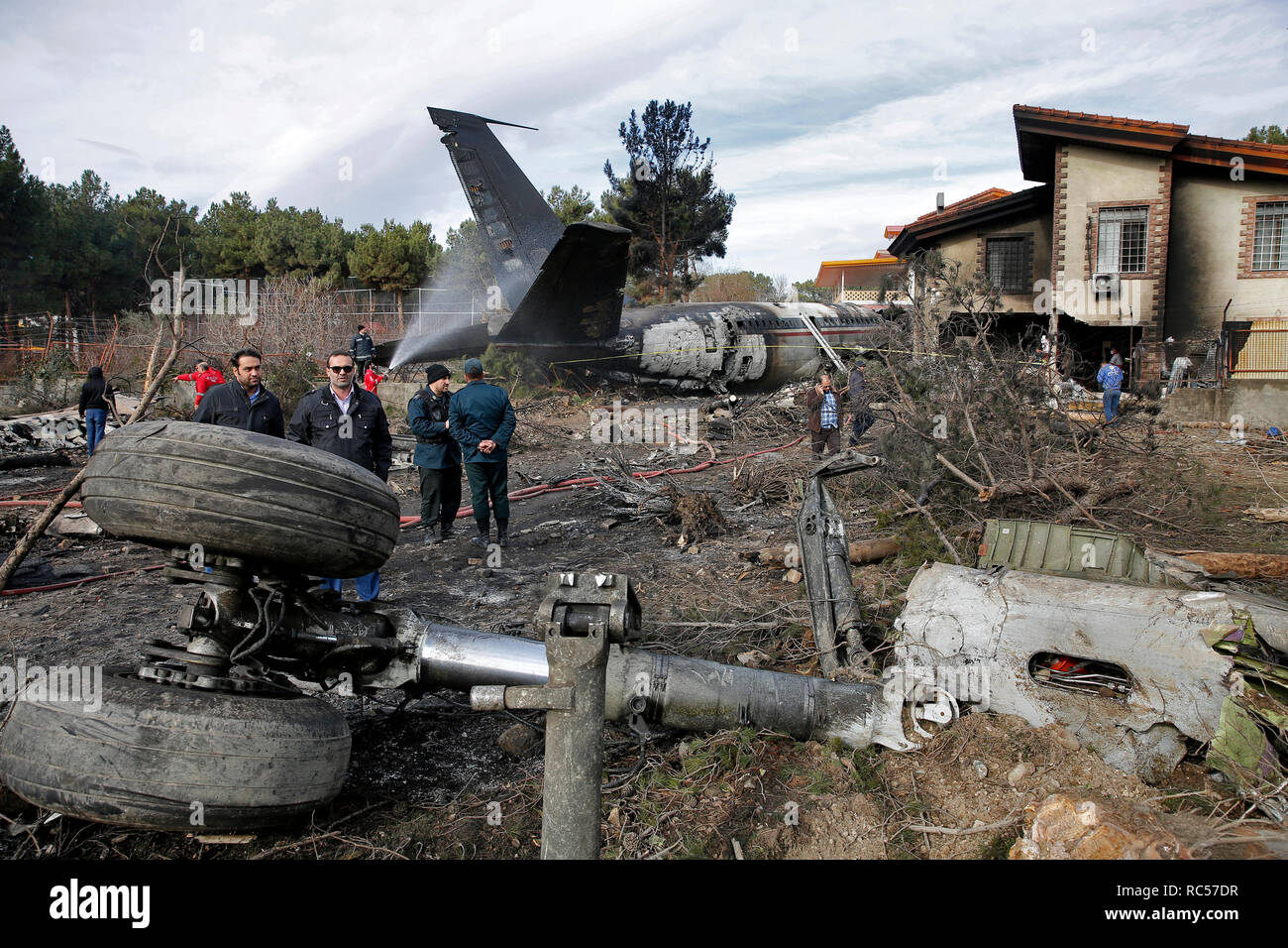 Questa foto fornite da Mizan News Agenzia iraniana mostra il personale di soccorso e sicurezza sul lavoro presso il sito di un Boeing 707 cargo aereo crash, a Fath aeroporto circa 40 chilometri (25 miglia) ad ovest di Tehran, Iran, lunedì, 14 gennaio 2019. Il governo iraniano di emergenza ufficiali di gestione ha raccontato la tv di stato che 16 persone erano a bordo di un Boeing 707 cargo aereo che si è schiantato a ovest di Teheran e che ci è noto un unico superstite. (Hasan Shirvani/Mizan News Agency via AP) Foto Stock