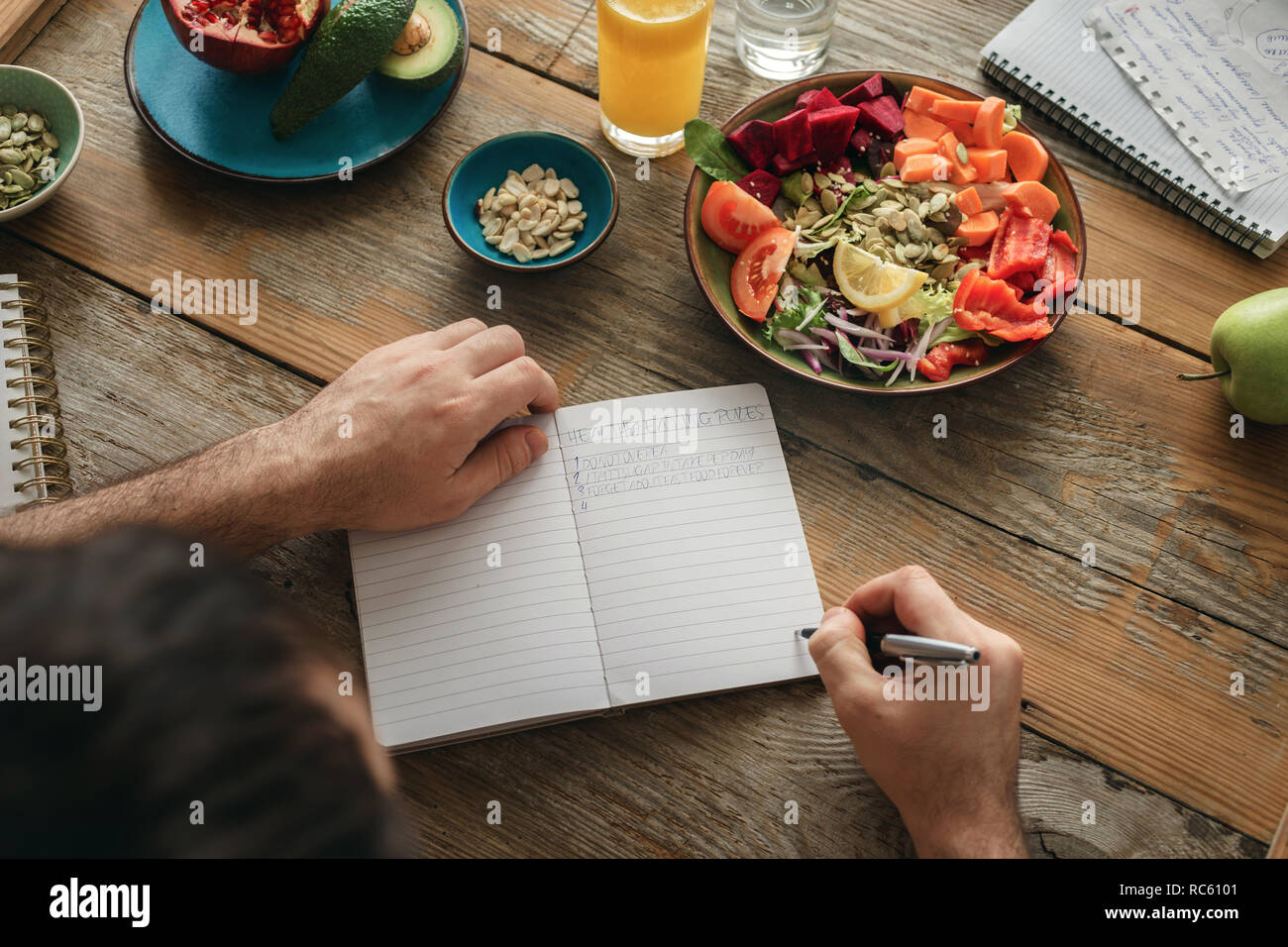 L'uomo fa un elenco di alimenti sani. Uno stile di vita sano dieta concetto alimentare Foto Stock