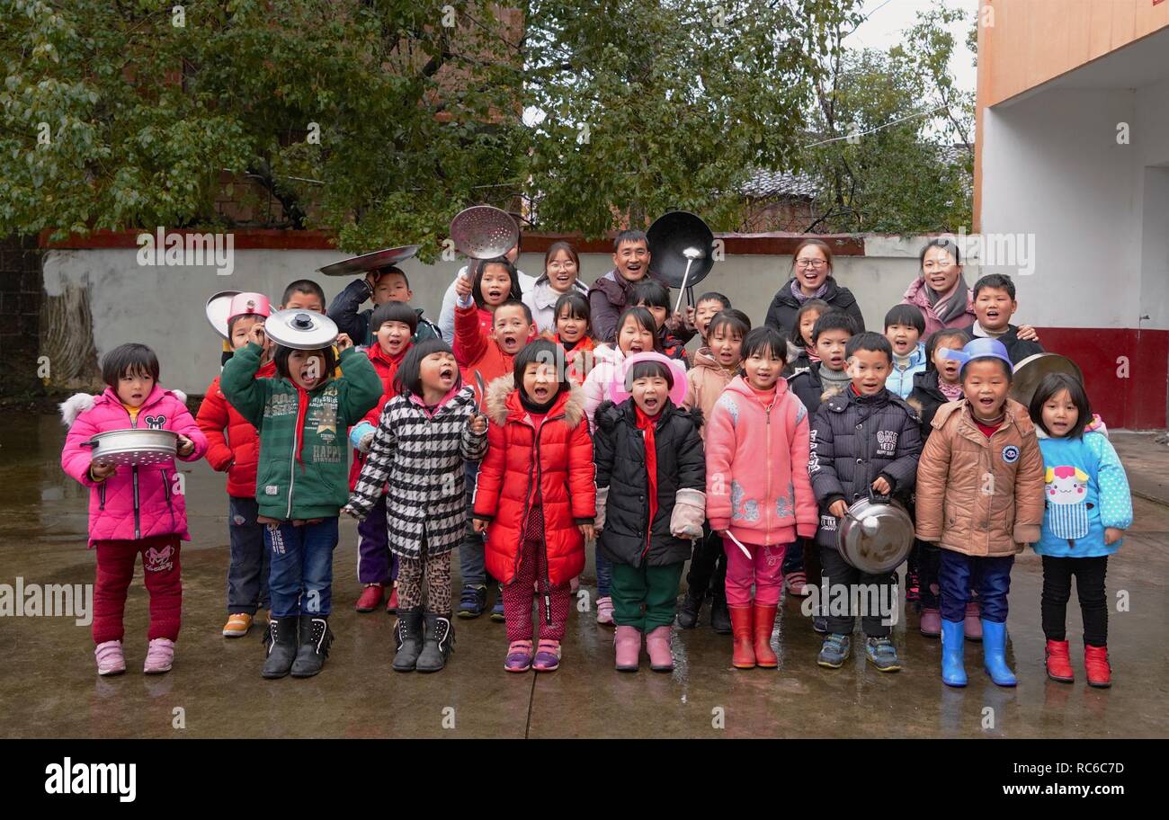 (190114) -- NANCHANG, 14 gennaio 2019 (Xinhua) -- PRESIDE Zhang Zhanliang pone con tutti gli insegnanti e gli studenti per foto a Huangni scuola elementare di Chuntao città di Yujiang distretto della città Yingtan, Cina orientale della provincia di Jiangxi, gen. 4, 2019. Zhang Zhanliang, il principale di Huangni scuola primaria, è stato conosciuto a livello nazionale di recente per prendersi cura della scuola a sinistra dietro i bambini i cui genitori sono lavoratori migranti nei paesi e nelle città. Per anni, non c'è la mensa a Huangni scuola elementare. Designato come principale nel 2018, Zhang Zhanliang speso il proprio denaro cottura mi aggiuntivi Foto Stock