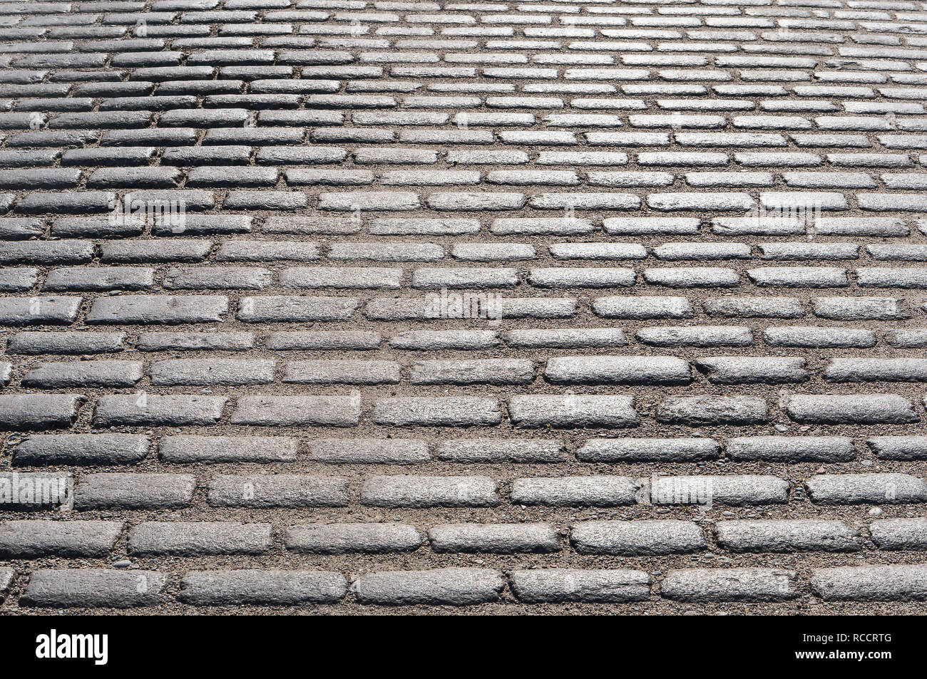 Una pavimentazione liscia pietra, pavimentazione stradale sassi, ciottoli Foto Stock