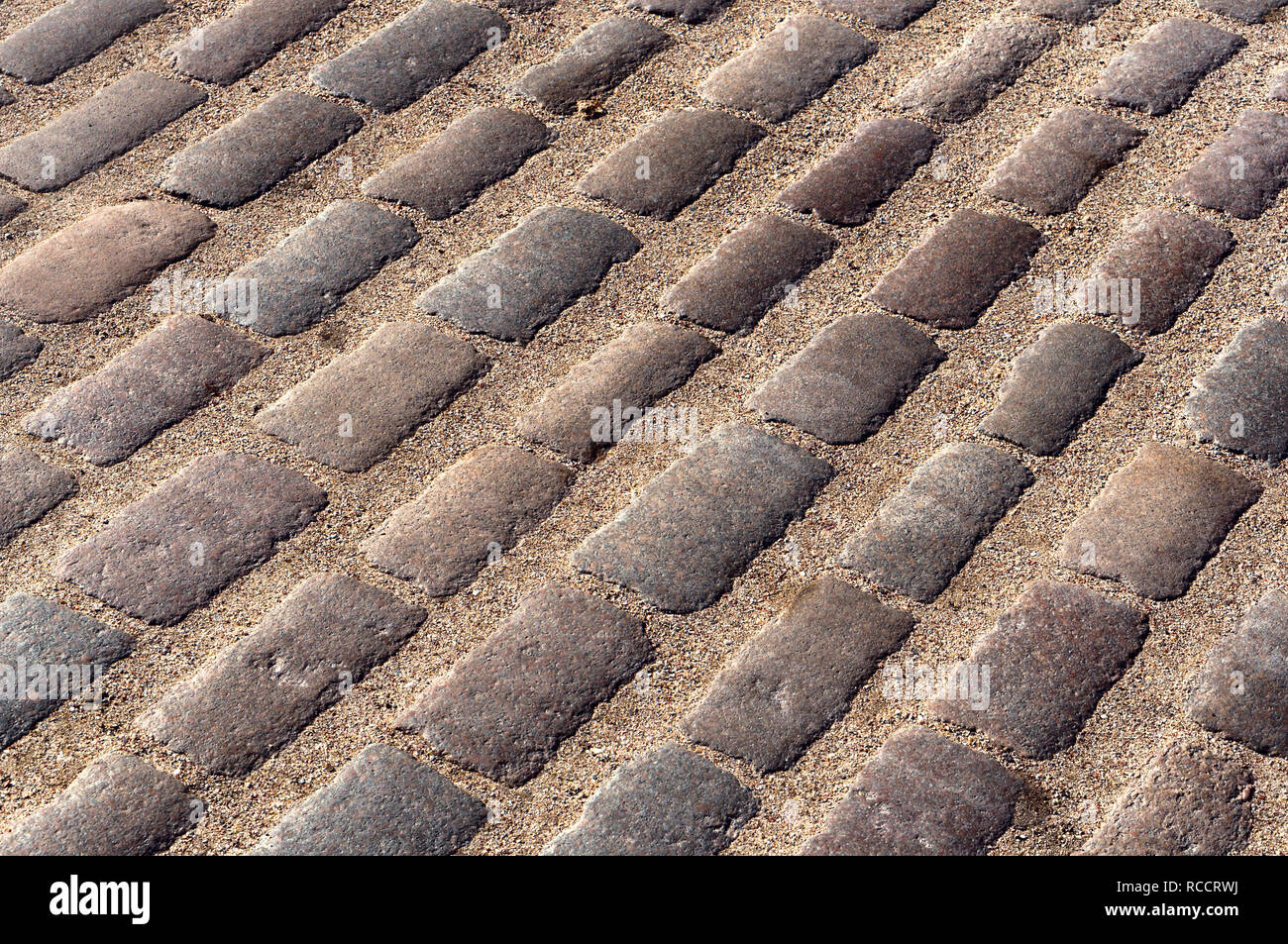 Una pavimentazione liscia pietra, pavimentazione stradale sassi, ciottoli Foto Stock