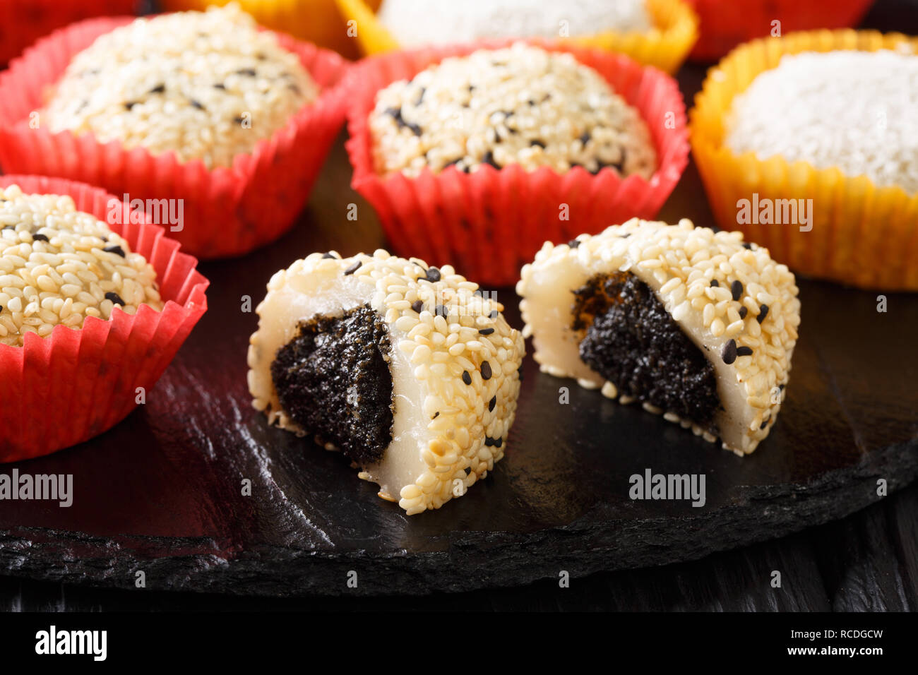 Dolce giapponese mochi daifuku con anko e sesamo vicino sul tavolo. Posizione orizzontale Foto Stock