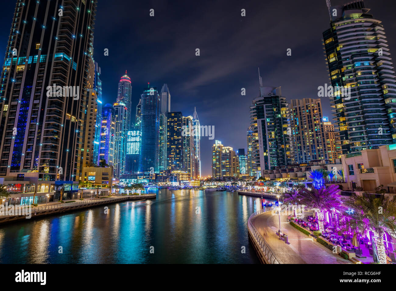 Dubai Marina a piedi di notte con edifici illuminati, Emirati Arabi Uniti Foto Stock