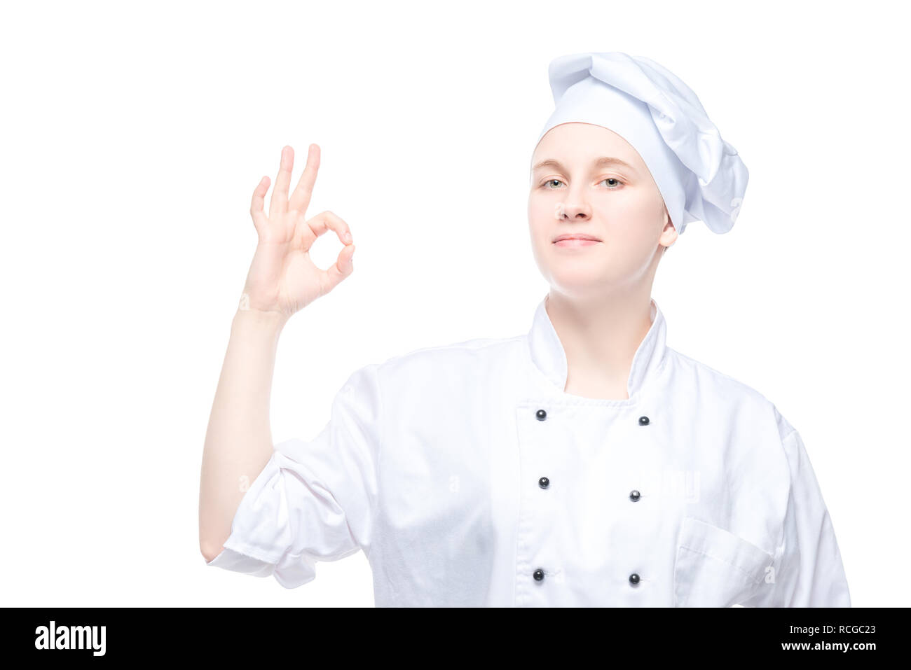 Lo chef femmina mostra gesti, soddisfatto ritratto su sfondo bianco Foto Stock