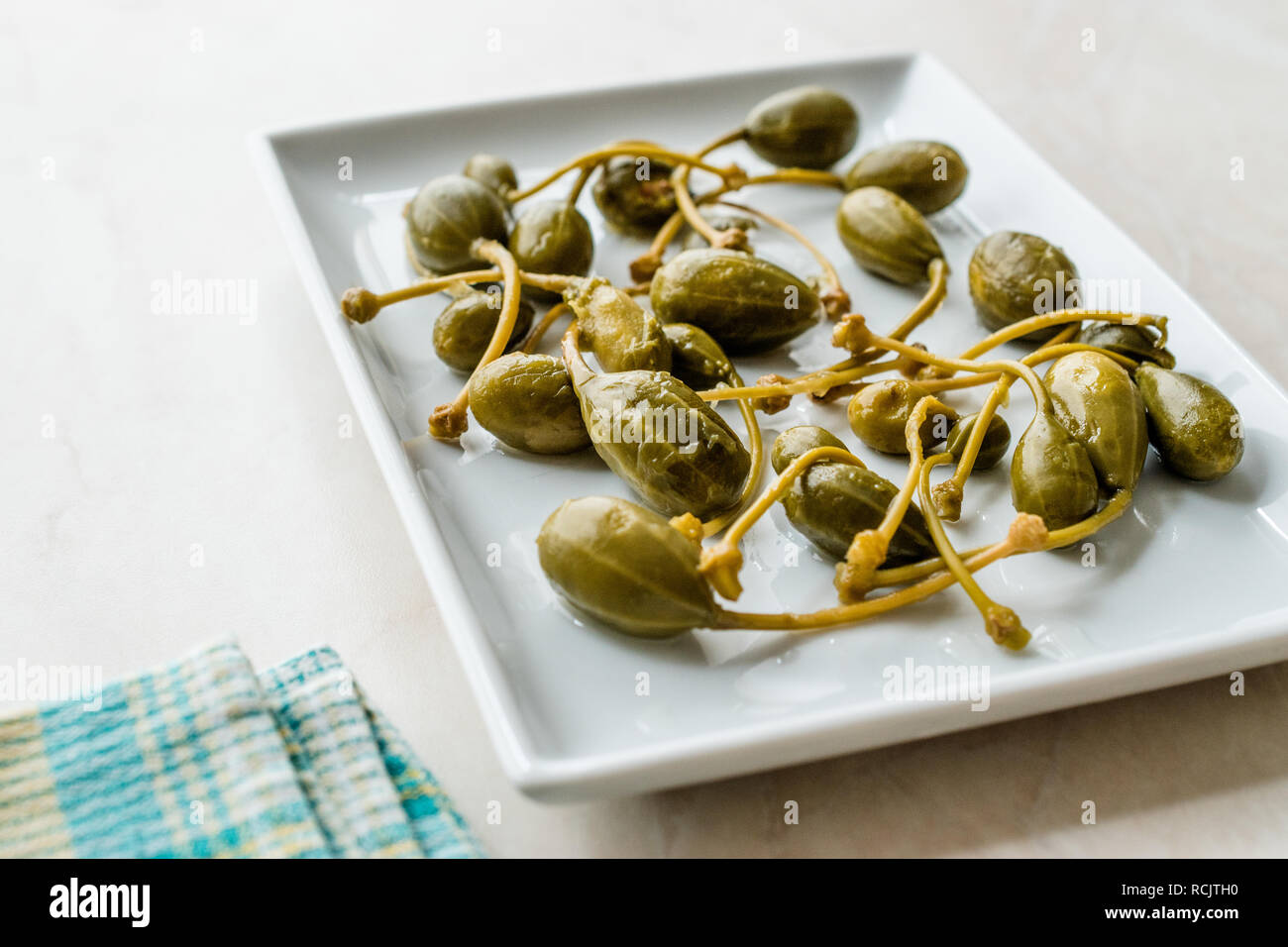 Decapati e conserve di capperi pronto a mangiare nella piastra. Alimenti biologici. Foto Stock