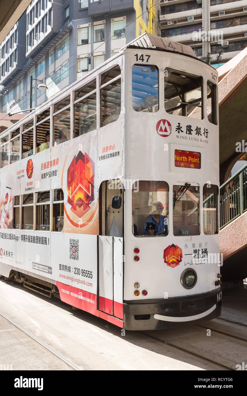 Il Tram che viaggiano attraverso il Distretto Centrale di Hong Kong Foto Stock