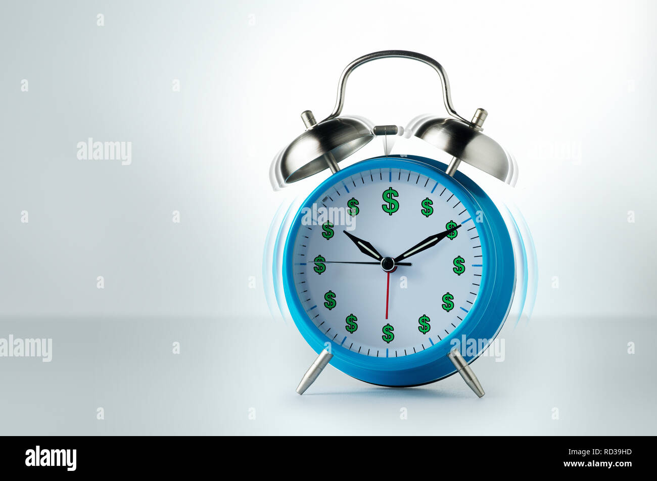 Orologio sveglia con segni di dollaro squilla con motion blur Foto Stock