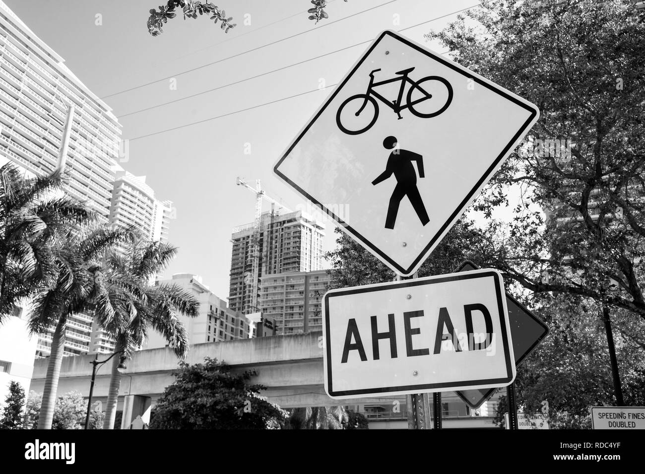 Segni di traffico sulla strada della città di Miami, Stati Uniti d'America. Bicicletta e attraversamento pedonale davanti avvertimento. Il trasporto di traffico e di viaggio. Attenzione e avvertire concetto. Foto Stock