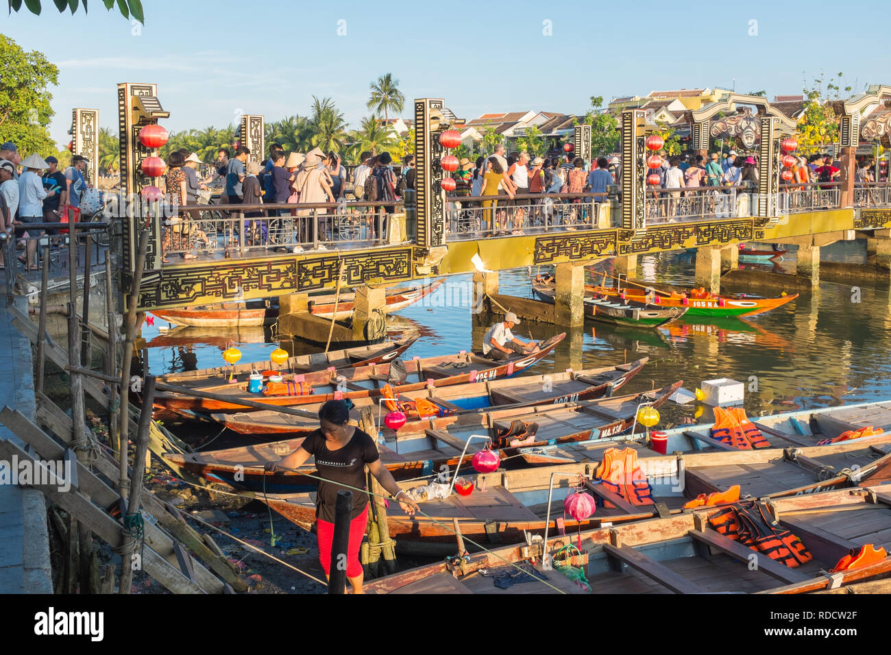 Piccole imbarcazioni in attesa di prendere i turisti per gite in barca sulle vie navigabili intorno alla città vietnamita di Hoi An in Quang Nam Provincia Foto Stock