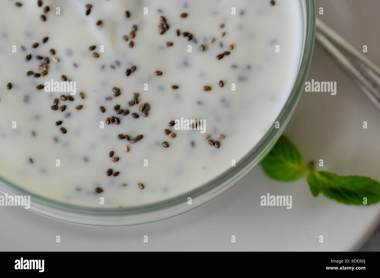 Sano cibo fitness - yogurt fatto in casa con super chia semi su un background in legno.Vista Superiore Foto Stock