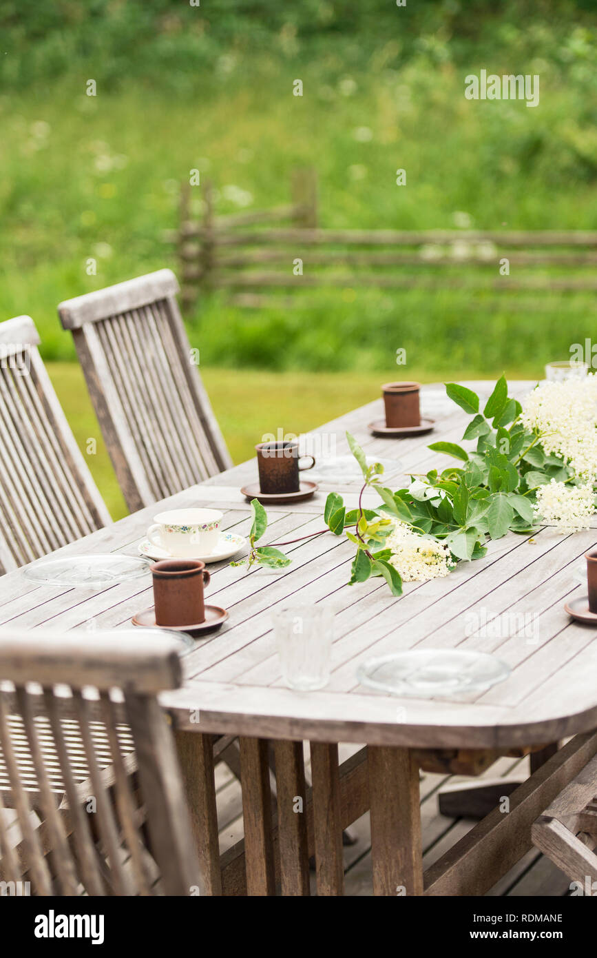 Tavolo in giardino con coppe Foto Stock