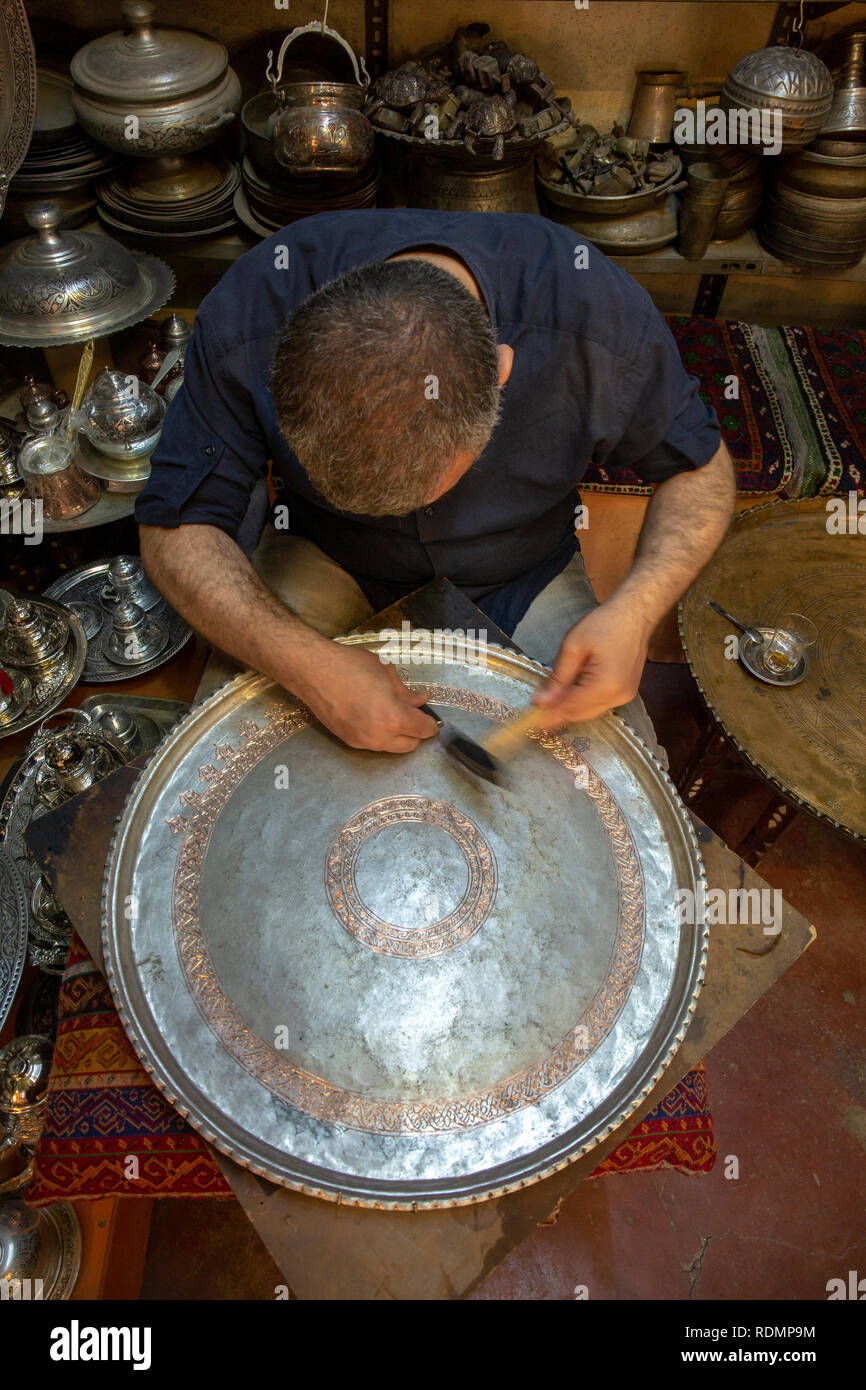 Gaziantep, Turchia - Giugno 07, 2014: artigiano lavorare su un vassoio di rame in Bakircilar Bazaar di Gaziantep, Turchia il 07 giugno 2014. Foto Stock