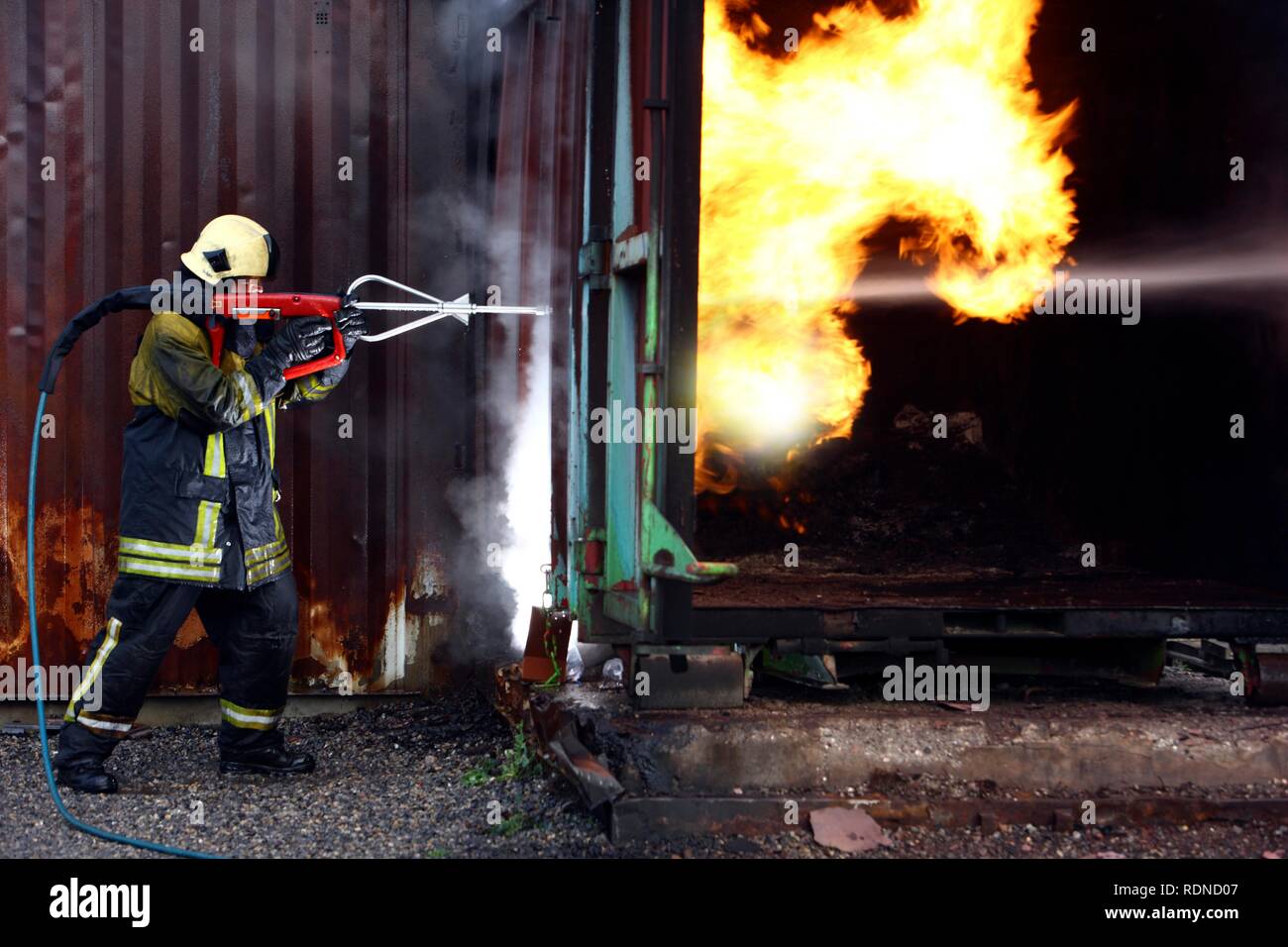 Alta pressione sistema di estinzione, Cobra, il servizio antincendio del centro di formazione, calore di un vigile del fuoco che dimostrano la possibilità Foto Stock