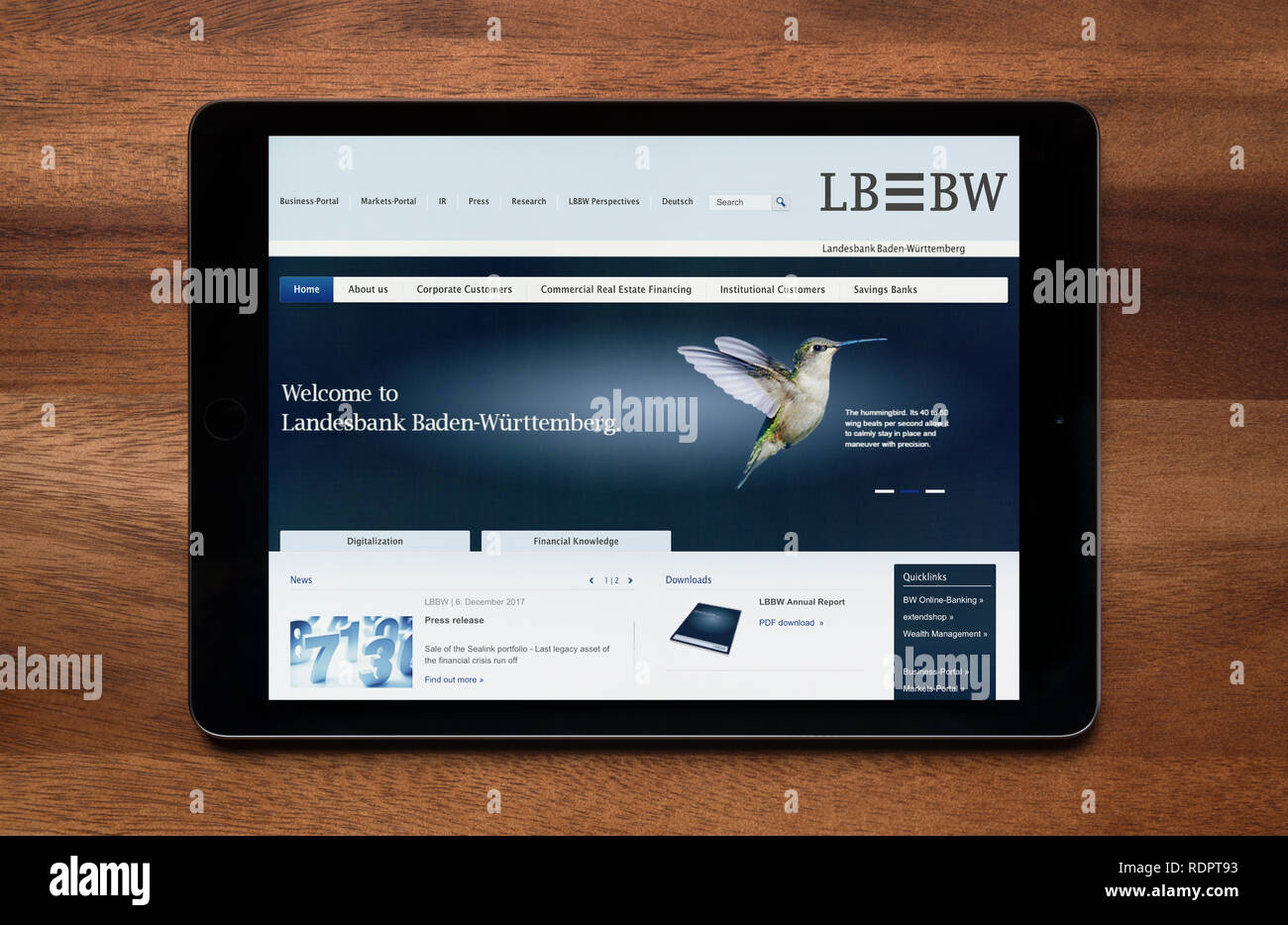 Il sito web di LB BW (Landesbank Baden-Württemberg) è visto su un tablet iPad, il quale è appoggiato su un tavolo di legno (solo uso editoriale). Foto Stock