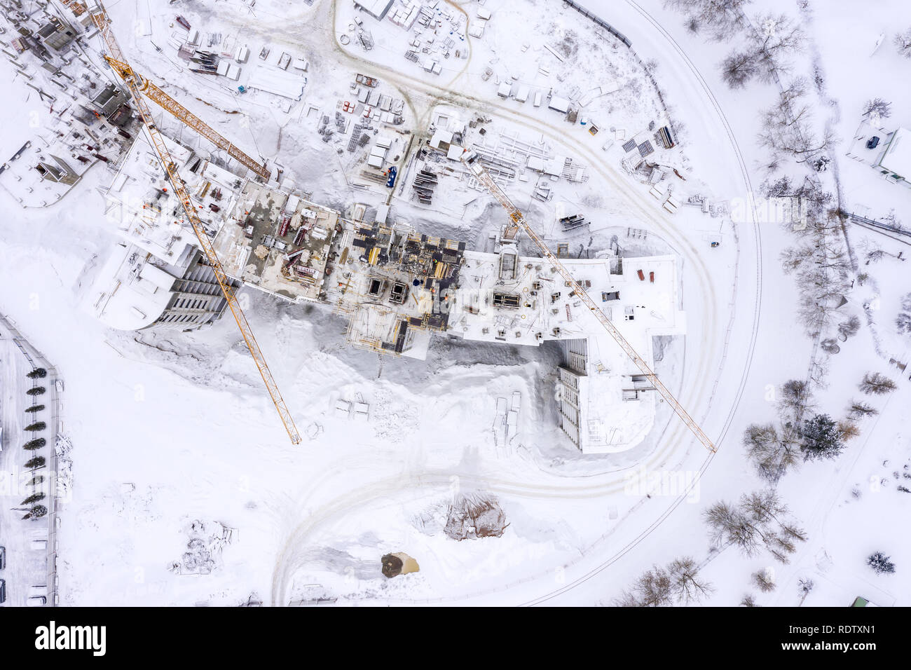 Vista superiore della costruzione di sfondo del sito, drone fotografia. gru a torre e attrezzature per l'edilizia in snow Foto Stock