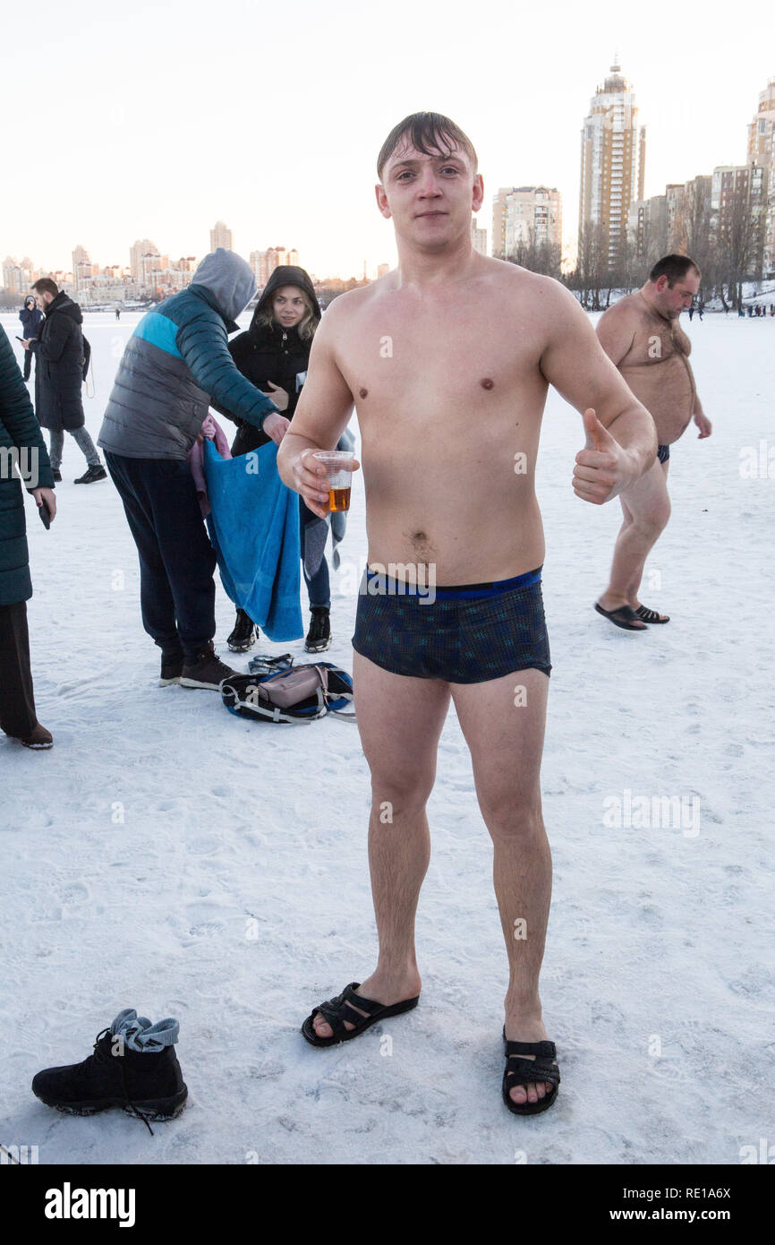 Giovane uomo in mutande si erge su ghiaccio vicino epifania nuoto posto alla regione Obolon a Kiev dopo immergere in acqua fredda su gennaio epifania celebrazione. Foto Stock