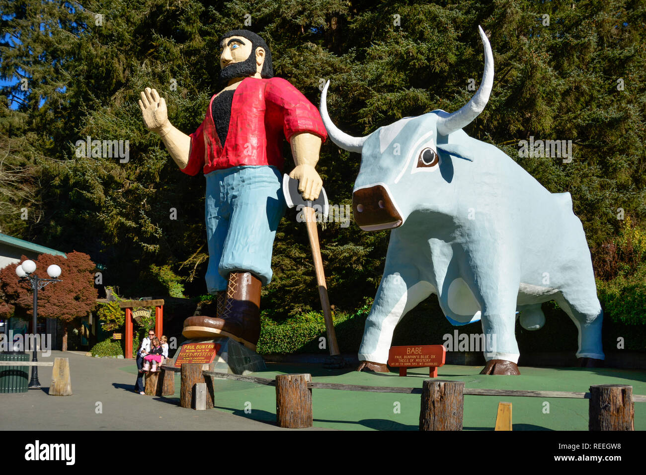 Famiglia tenendo selfie con statue di Paul Bunyan e il suo bue Babe ad alberi di mistero in Redwoods della California del nord. Foto Stock