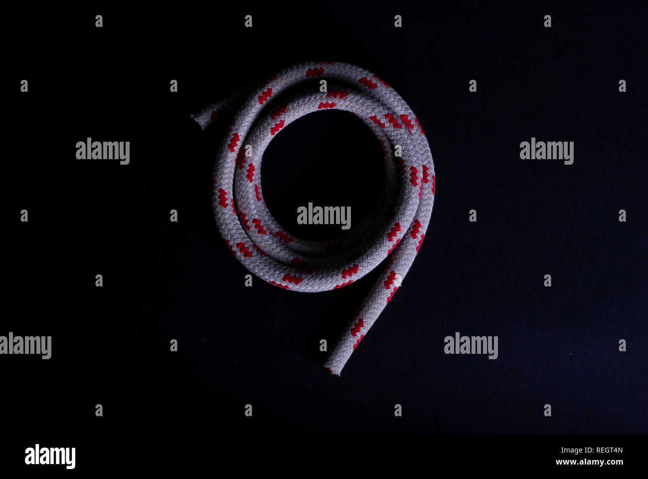 Vista dall'alto di un rosso e bianco corda a vela su sfondo nero Foto Stock