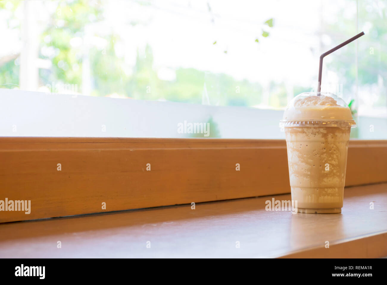 Miscele di caffè è molto popolare in Asia, confezionati in vetro di plastica. È una bevanda rinfrescante e drink fresco collocato su un tavolo di legno. Foto Stock