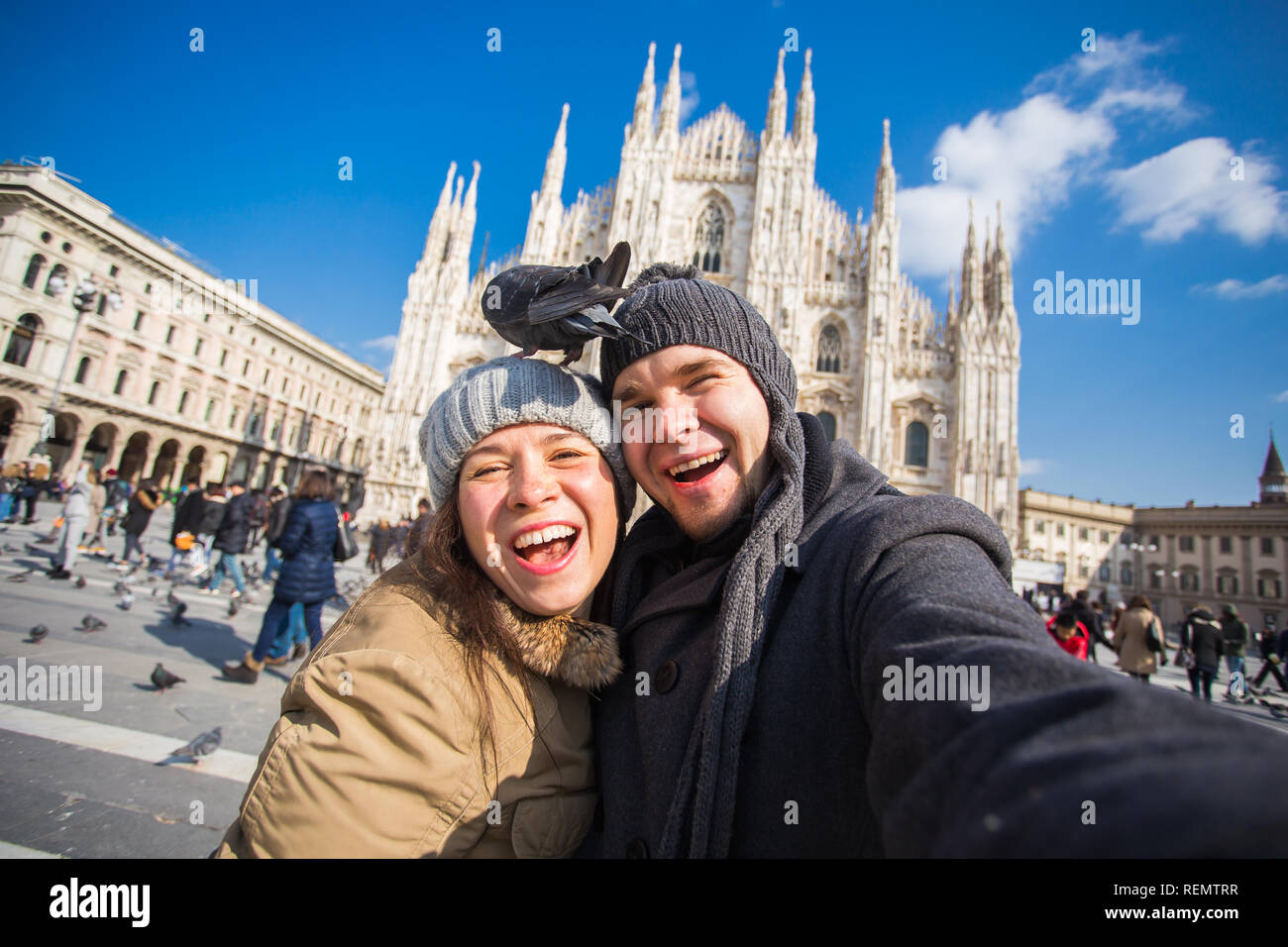 Viaggi, Italia e divertente giovane concetto - Happy turisti prendendo un autoritratto con piccioni nella parte anteriore del Duomo di Milano Foto Stock