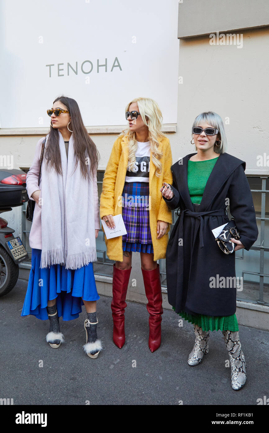 Milano, Italia - 13 gennaio 2019: Le donne con gonna blu, giallo cappotto e abito verde prima di John Richmond sfilata di moda, la Settimana della Moda Milanese street style Foto Stock