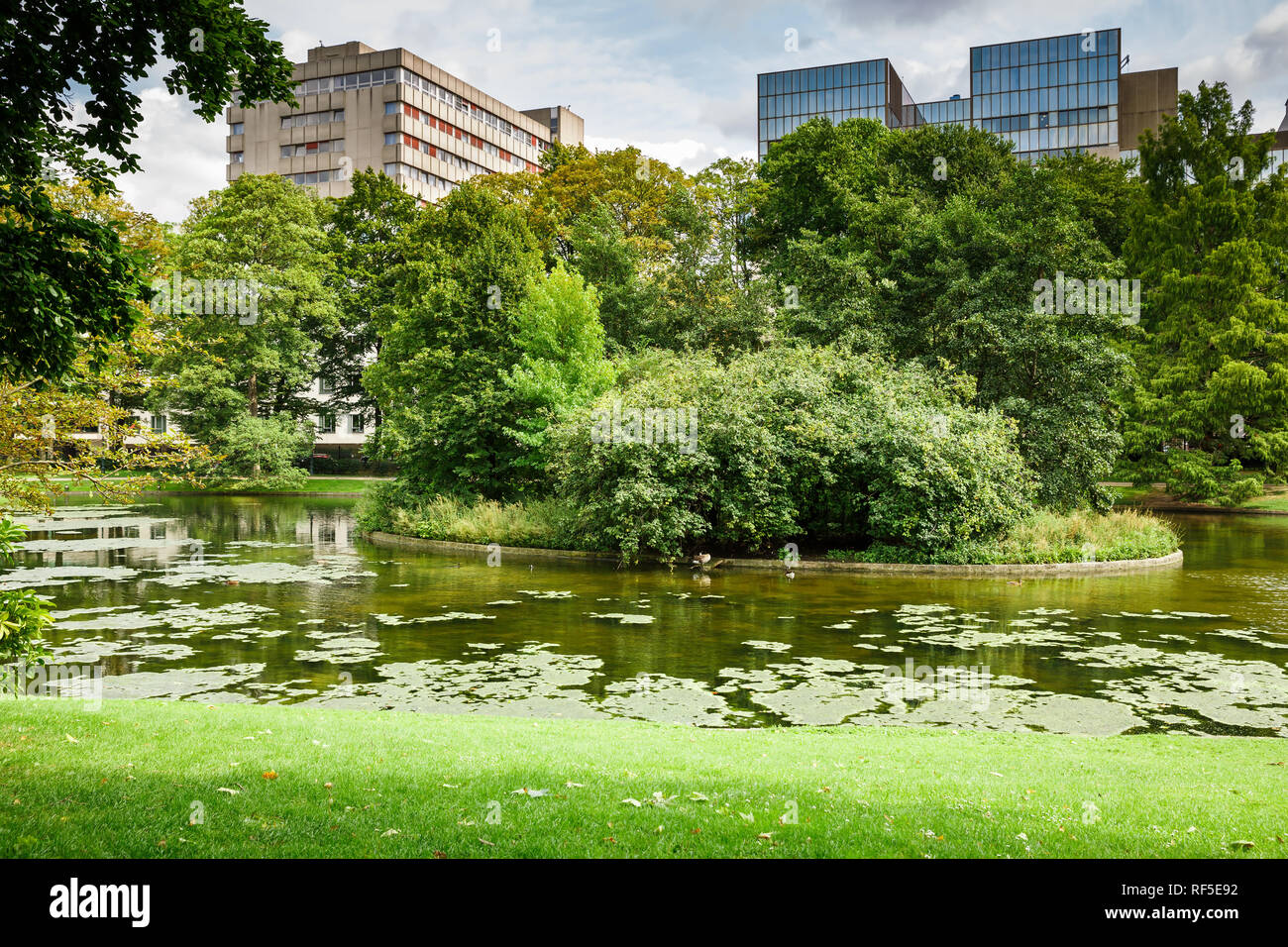 Parco Leopold con stagno, alberi ed edifici a Bruxelles, in Belgio. Foto Stock