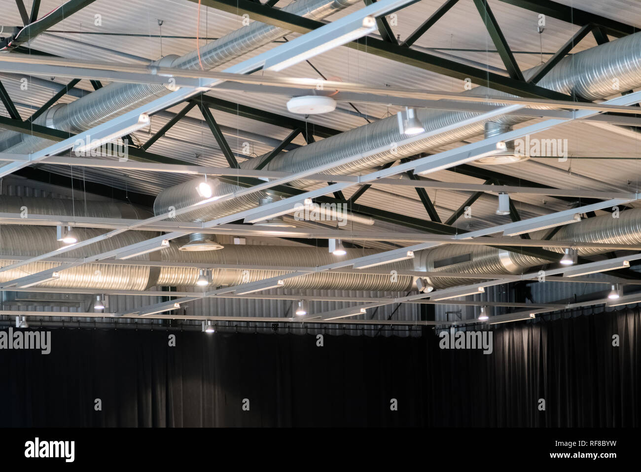 Edificio di fabbrica o magazzino edificio. Vasto spazio vuoto con tubi di ventilazione e luci Foto Stock