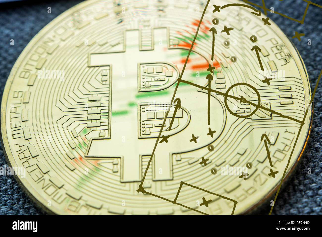 Primo piano della golden bitcoin moneta con la foto del calcio archiviato con gioco di tattica e strategia tracciata su di esso Foto Stock