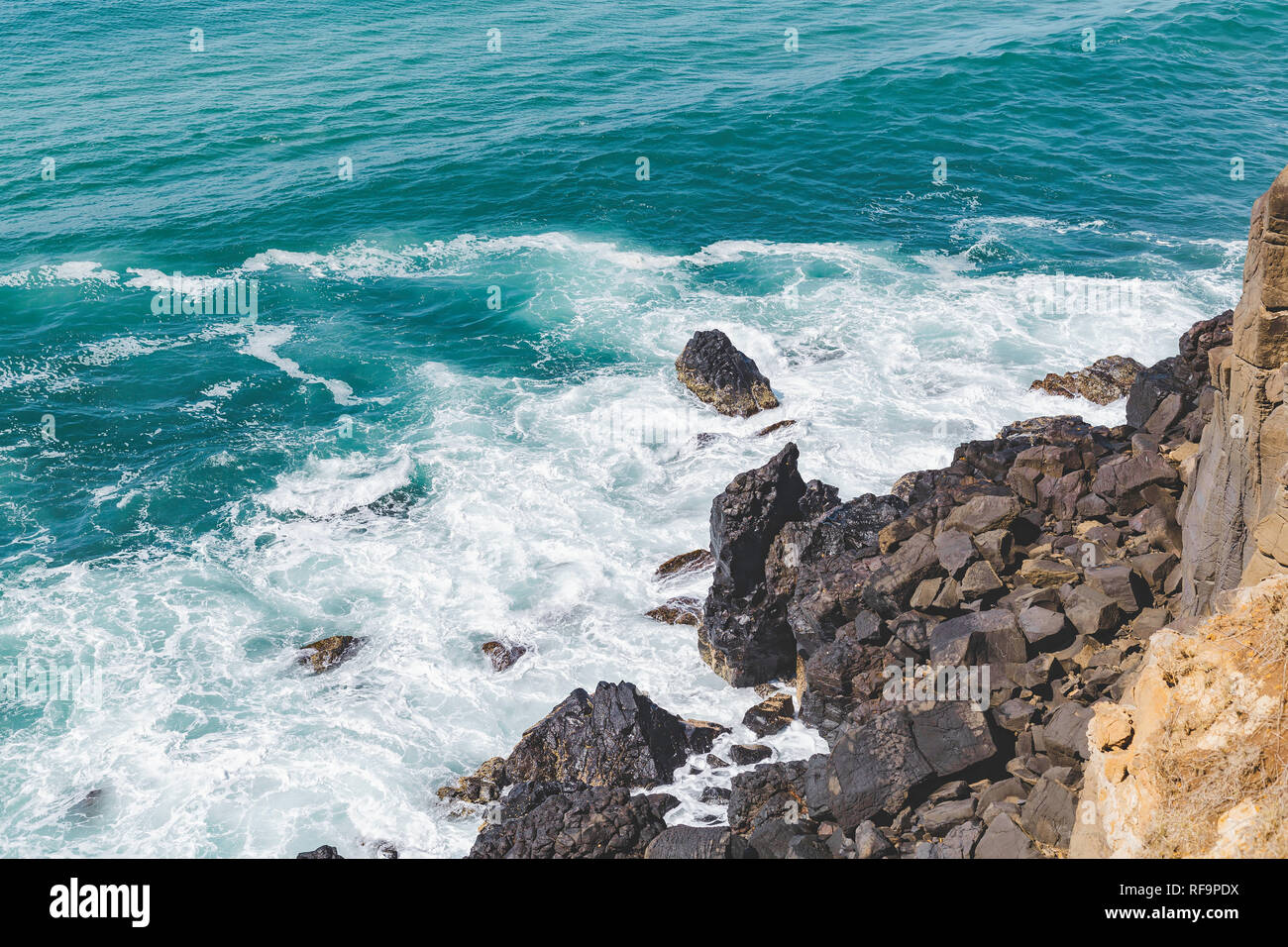 Sole che splende in giù su rocce di spruzzi Foto Stock