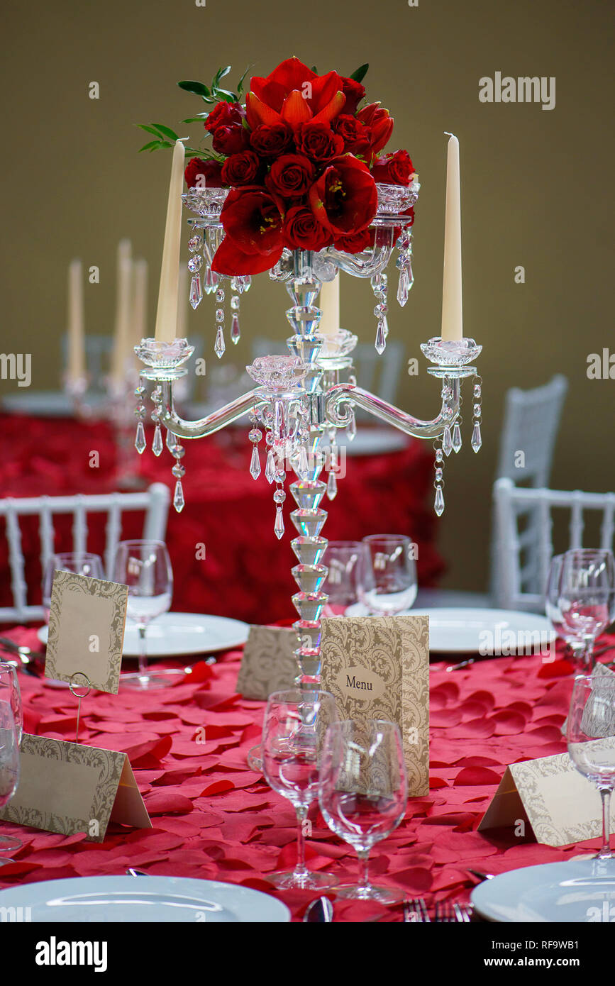 Un bellissimo candelabri di cristallo style portacandele centrotavola con  otto bobeche dentellato per candelabri e un rosso e tulipani bouquet di  rose Foto stock - Alamy