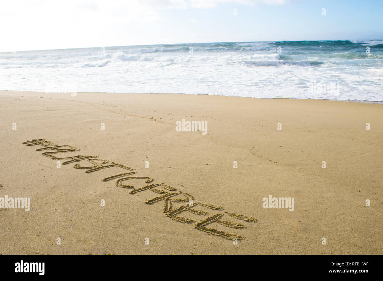 Iscrizione #plasticfree Scritta sulla sabbia sulle rive dell'oceano atlantico Foto Stock