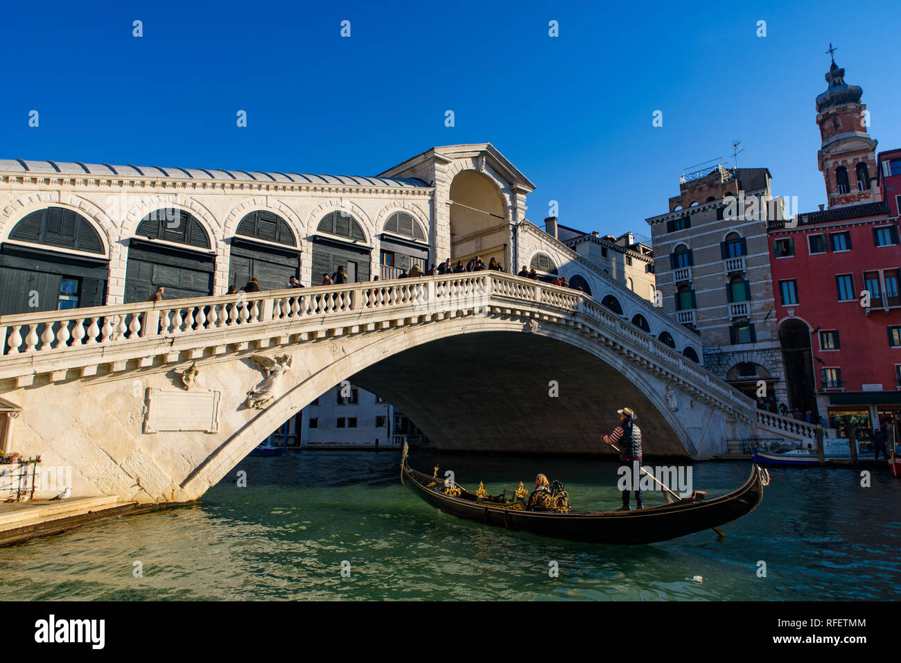 Gondola passando sotto il ponte di Rialto (Ponte de Rialto) attraverso il Grand Canal, Venezia, Italia Foto Stock