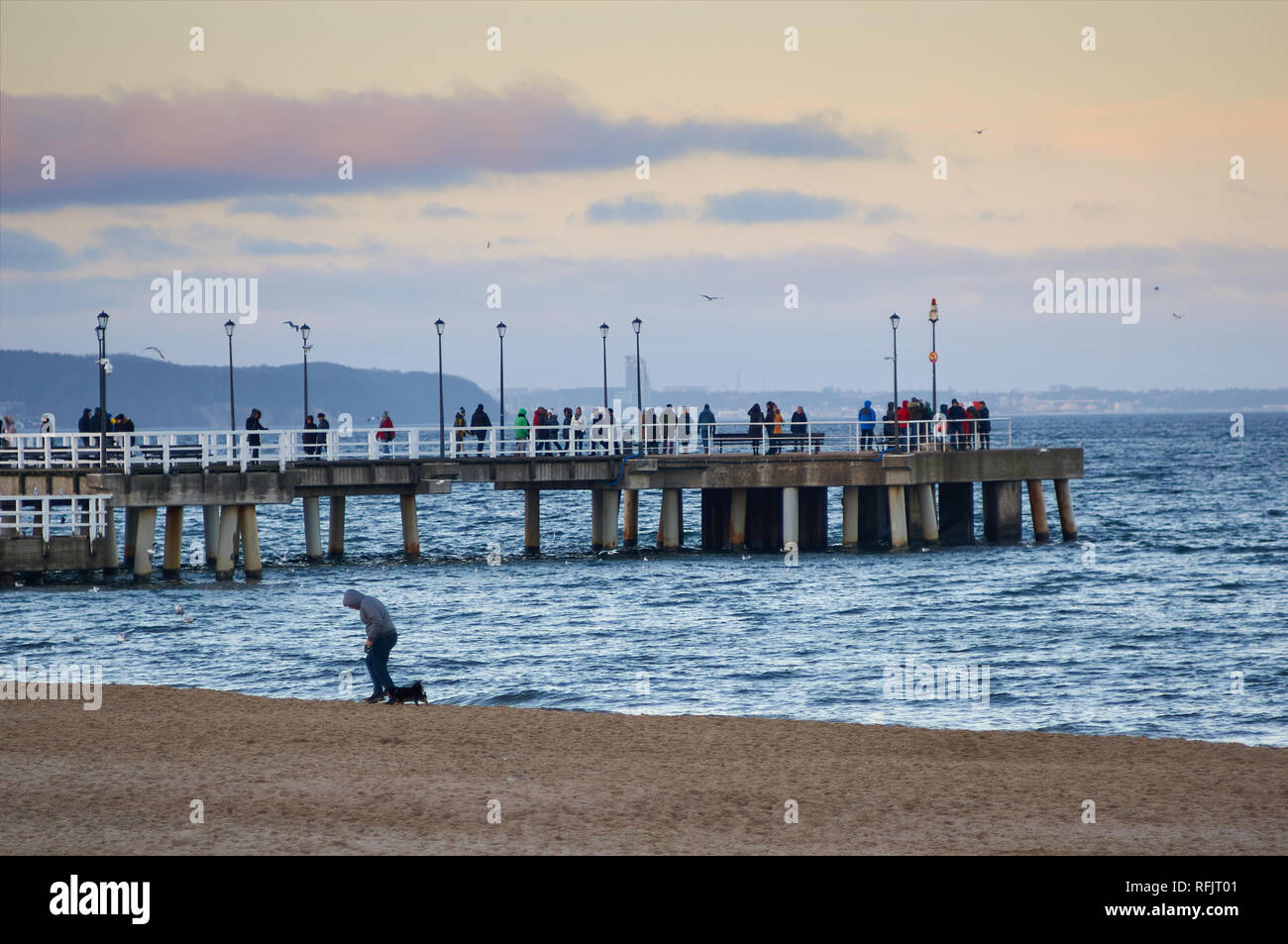 Persone che passeggiano lungo un molo in legno che si estendono nel Mar Baltico in Jelitkowo, Gdansk, Polonia Foto Stock