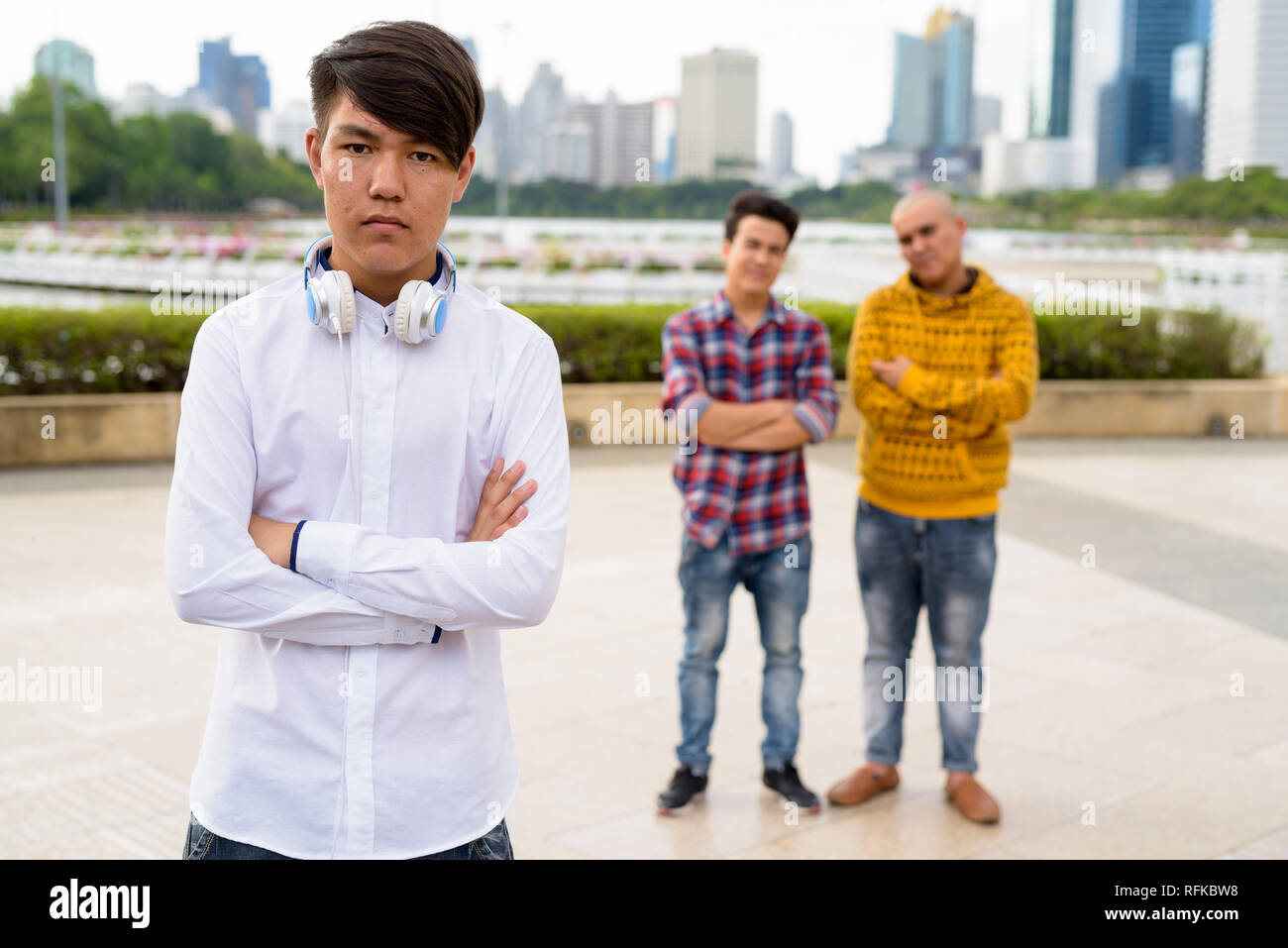 Tre giovani uomini asiatici di relax presso il parco insieme Foto Stock