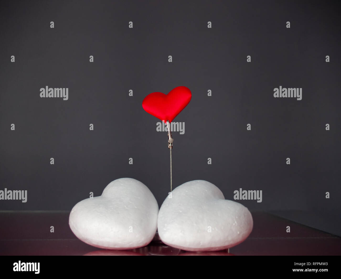 Concetto di amore ancora vita con rosso acceso candele, un cuore rosso e due cuori poliespan Foto Stock