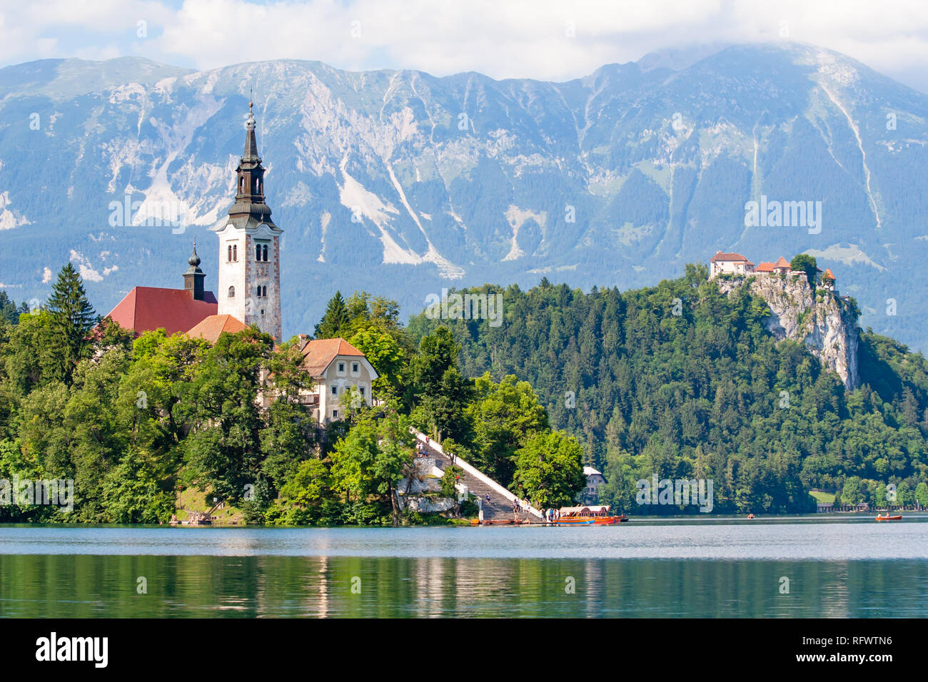 Piccola isola con una chiesa e un castello su una rupe e viste sulle montagne e sul lago di Bled, Slovenia, Europa Foto Stock