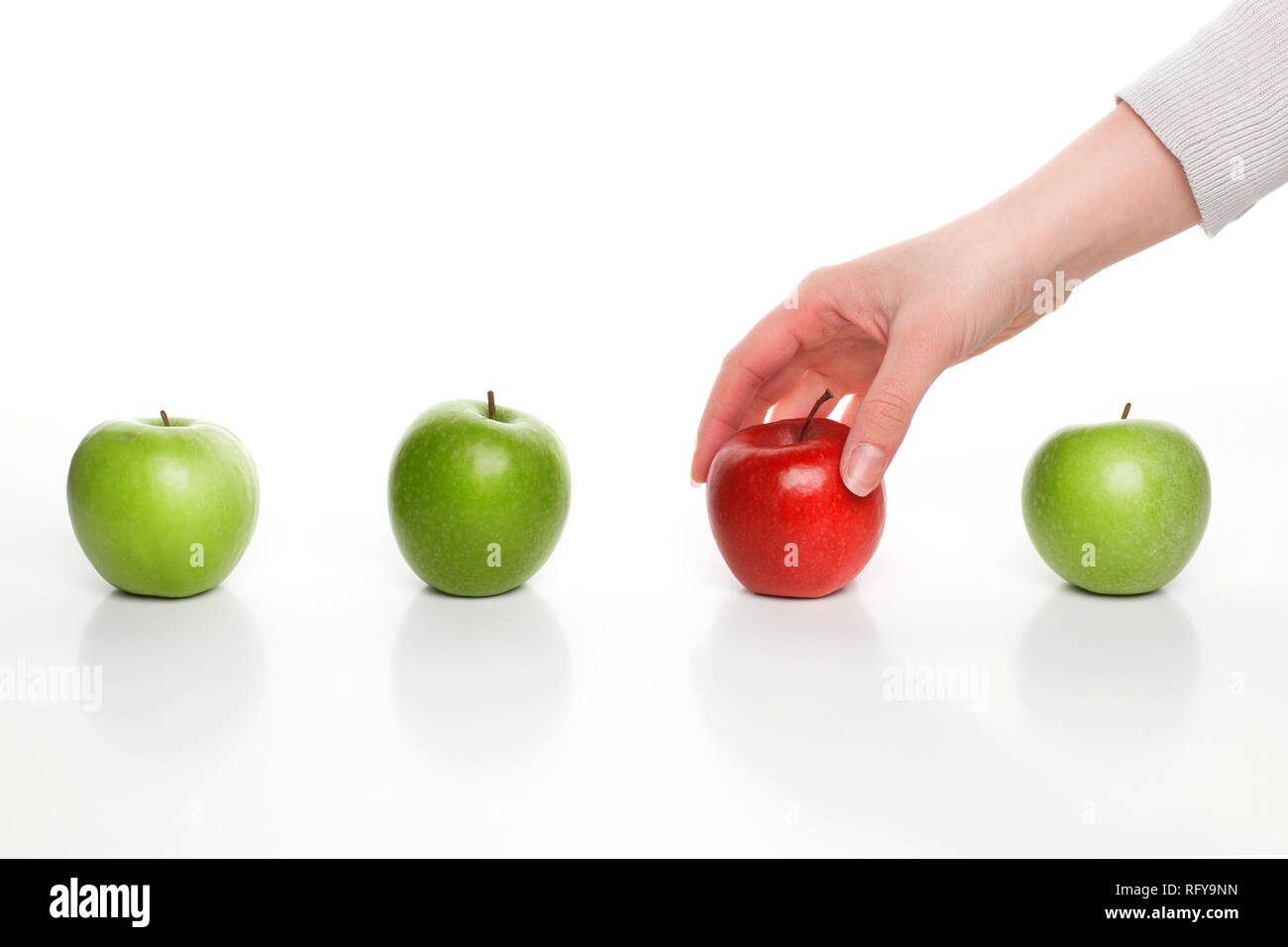 Raccolta a mano red apple tra mele verdi Foto Stock