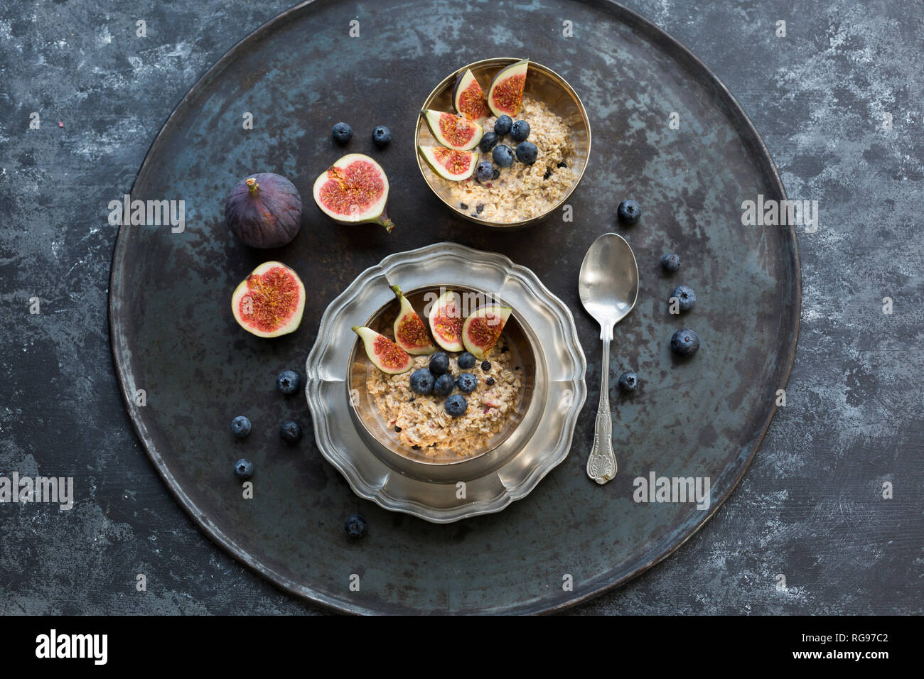 Bocce di porridge con spicchi di fichi, mirtilli e frutti di bosco essiccati Foto Stock