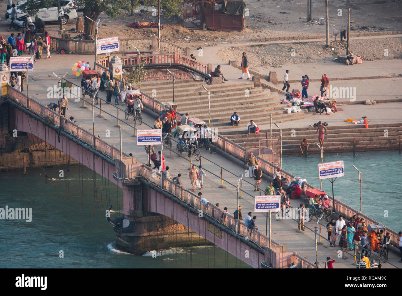 La gente sul ponte sul fiume Gange in Haridwar, India Foto Stock