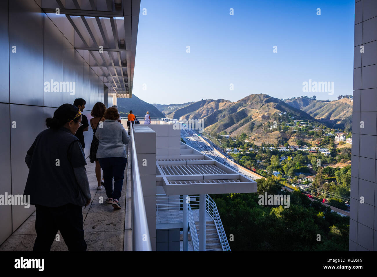 Giugno 8, 2018 Los Angeles / CA / STATI UNITI D'AMERICA - gruppo di visitatori sul libero tour architettonico di Getty Center; l'autostrada e vicine colline visibili in ba Foto Stock