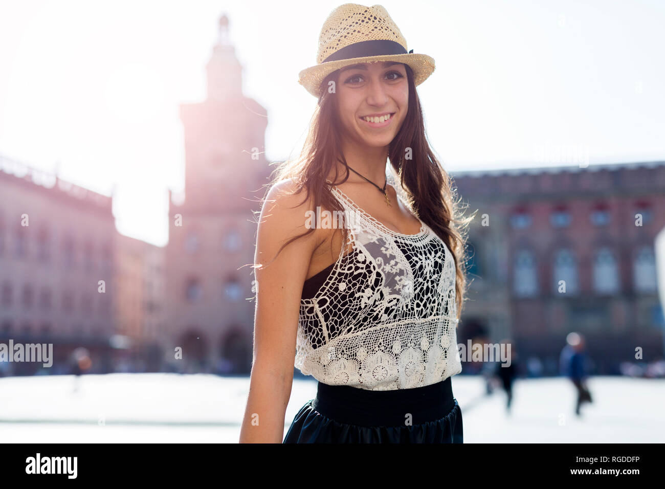 L'Italia, Bologna, ritratto di moda giovane donna indossa cappello di paglia a retroilluminazione Foto Stock