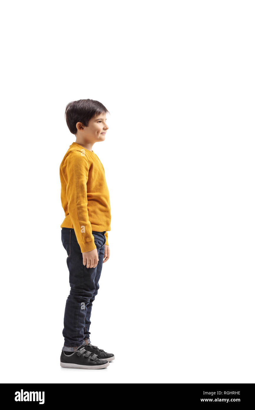 Lunghezza piena ripresa di profilo di un ragazzo in piedi e in attesa isolato su sfondo bianco Foto Stock