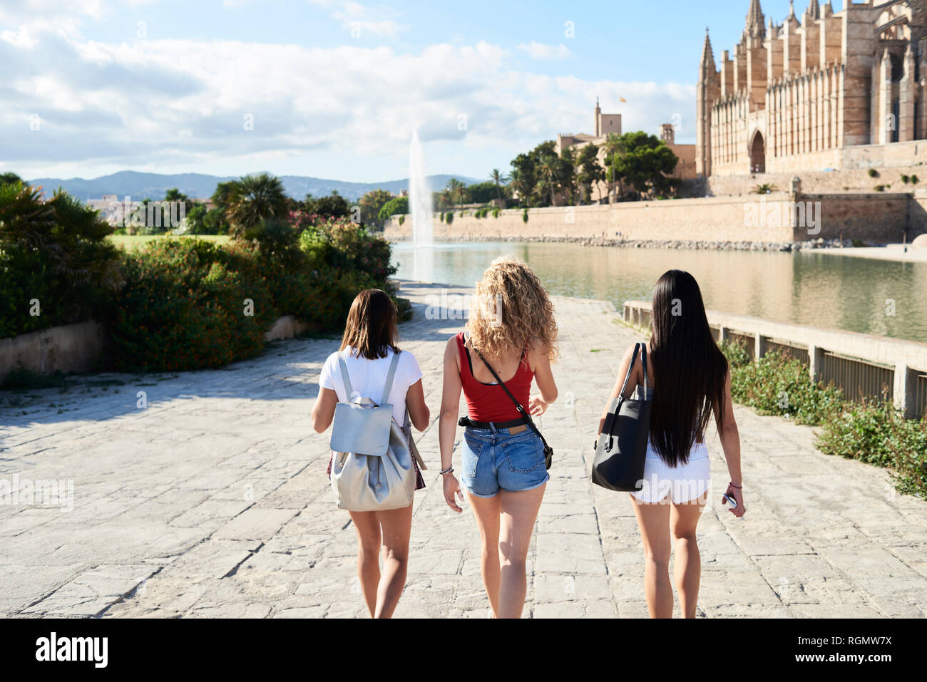 Spagna, Mallorca, Palma, vista posteriore di tre giovani donne ad esplorare in città Foto Stock