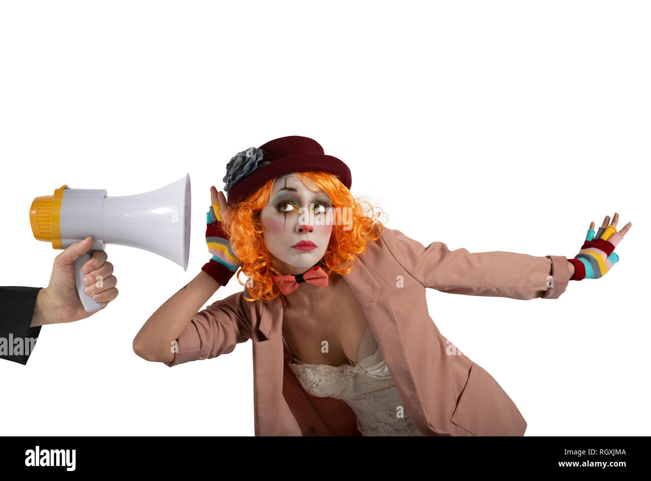 Funny clown sente un megafono con un messaggio. Isolato su sfondo bianco Foto Stock