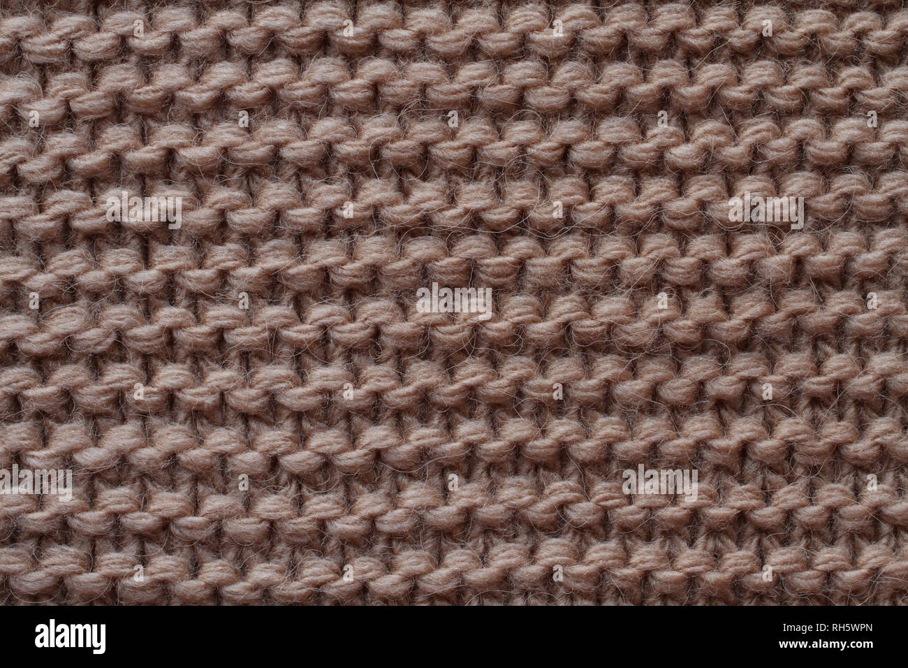 Luce di lana marrone di tessuto a maglia texture. Macro. Foto Stock