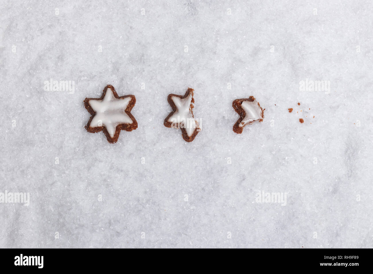 Nibbled off cannella stelle sulla neve bianca come simbolo del tempo di Avvento Foto Stock