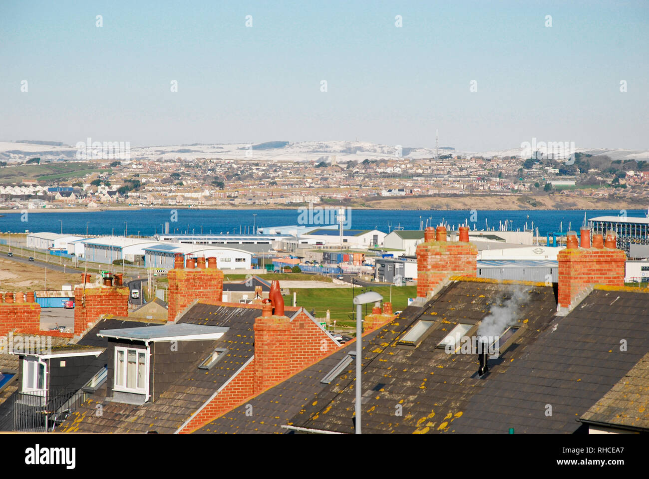 Isola di Portland, Dorset. Isola di Portland. 2° febbraio 2019. Versa a vapore da una casa di ventola di riscaldamento come il sole cade sulla neve sulle colline costiere, al di sopra di Weymouth Credito: stuart fretwell/Alamy Live News Foto Stock