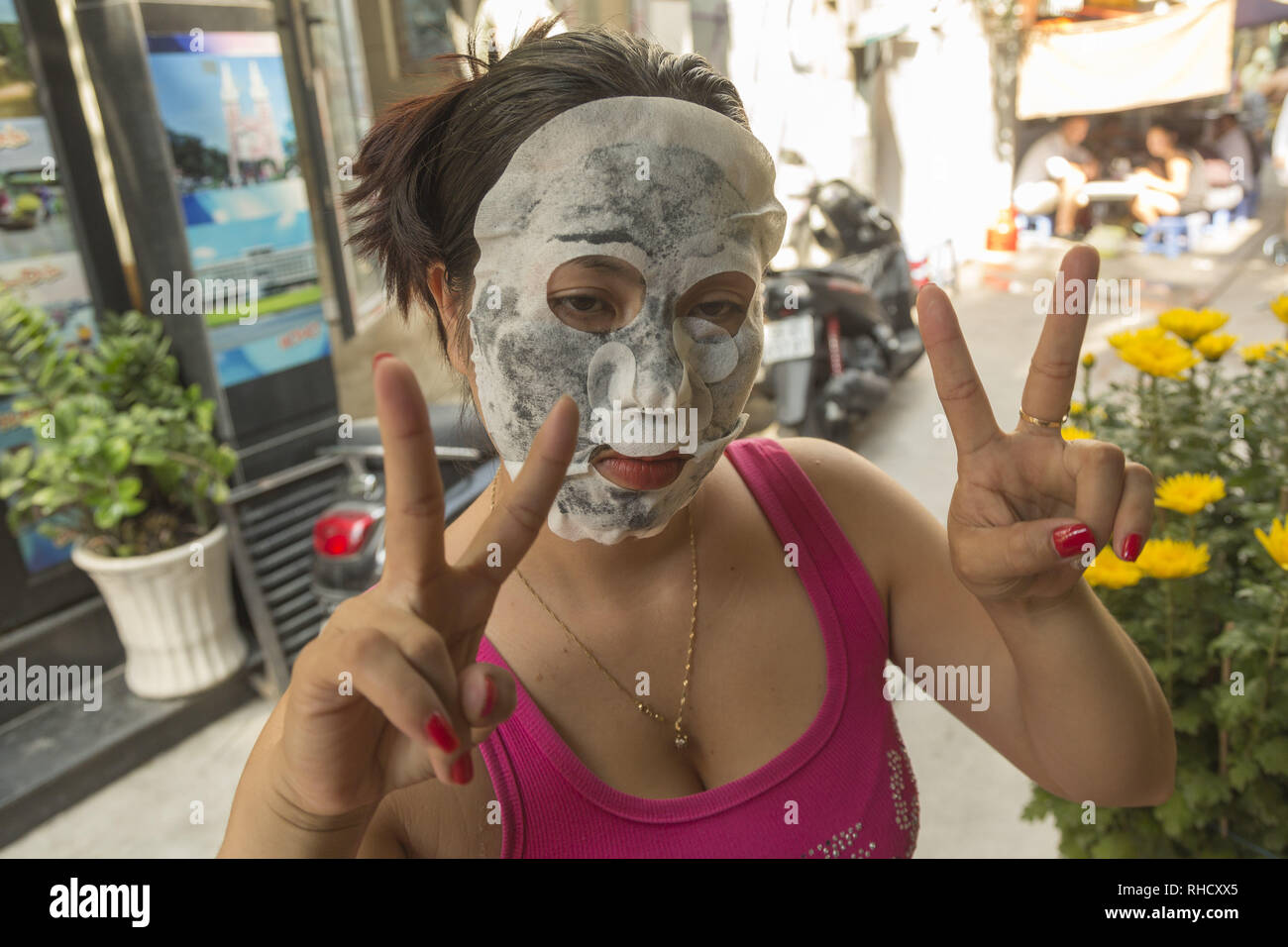 Giovane donna con la maschera per il viso Foto Stock