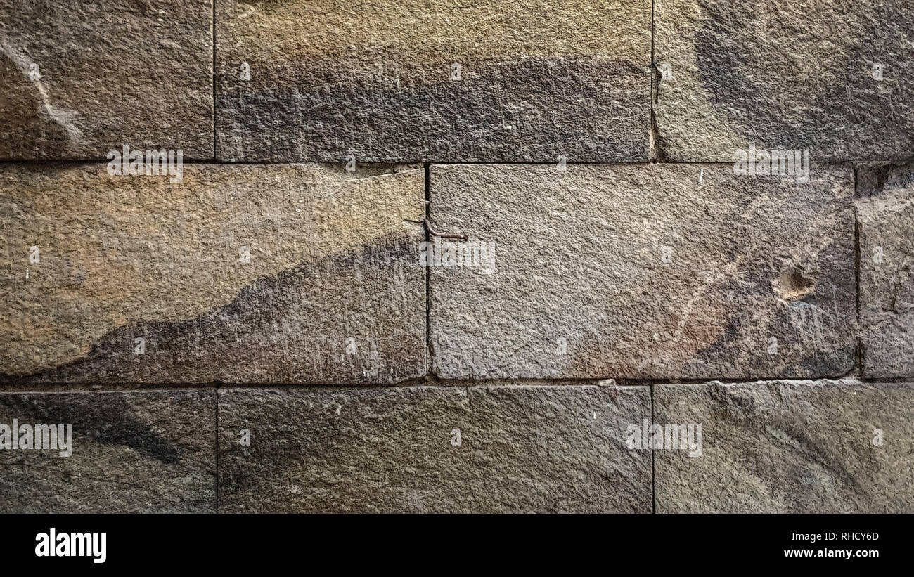 La parete è realizzata in pietra con una forma resistente Foto Stock
