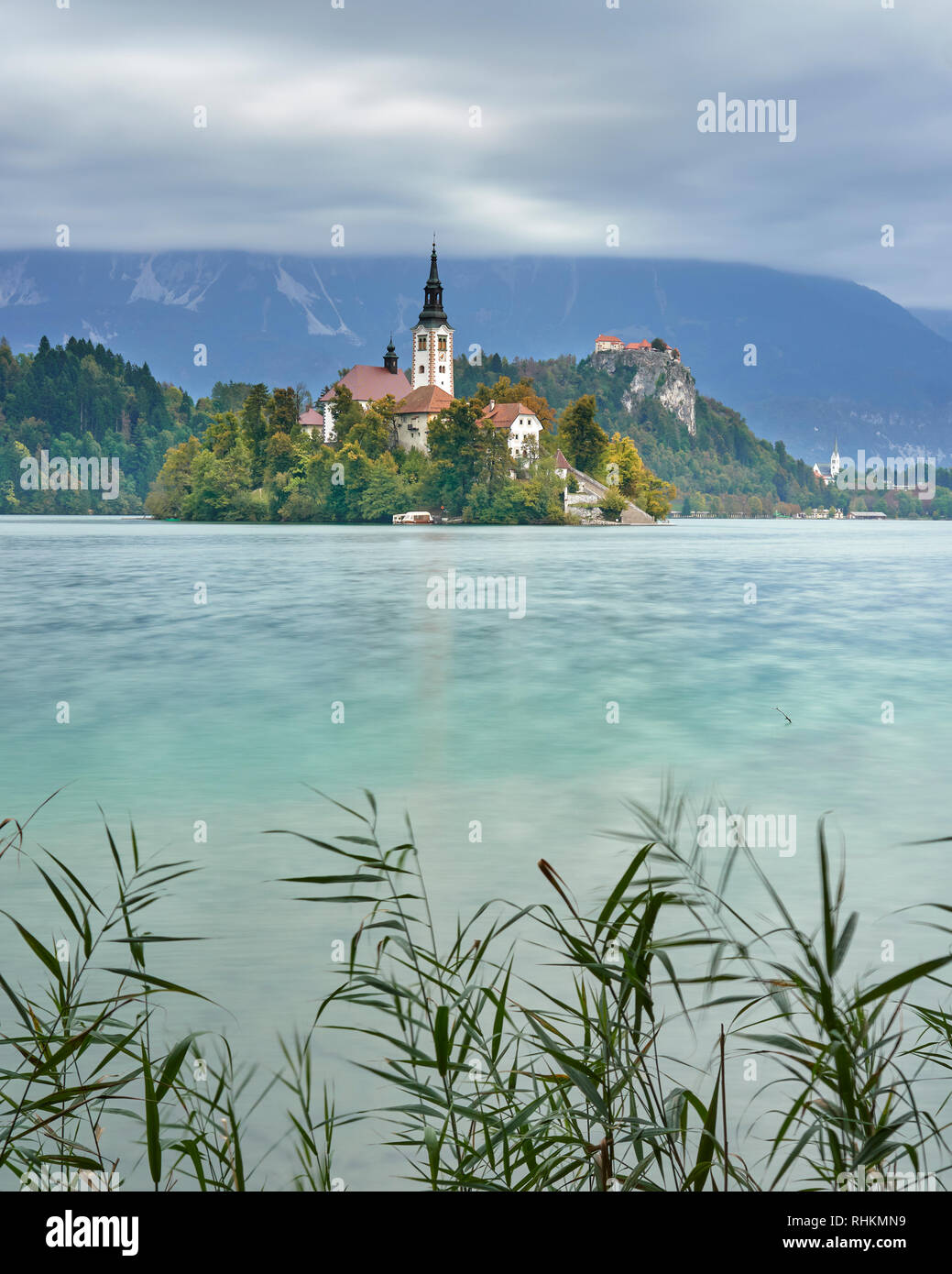 Chiesa dell'Assunzione su Blejski Otok con il castello di Bled, lago di Bled Bled, Gorenjska, Slovenia Foto Stock